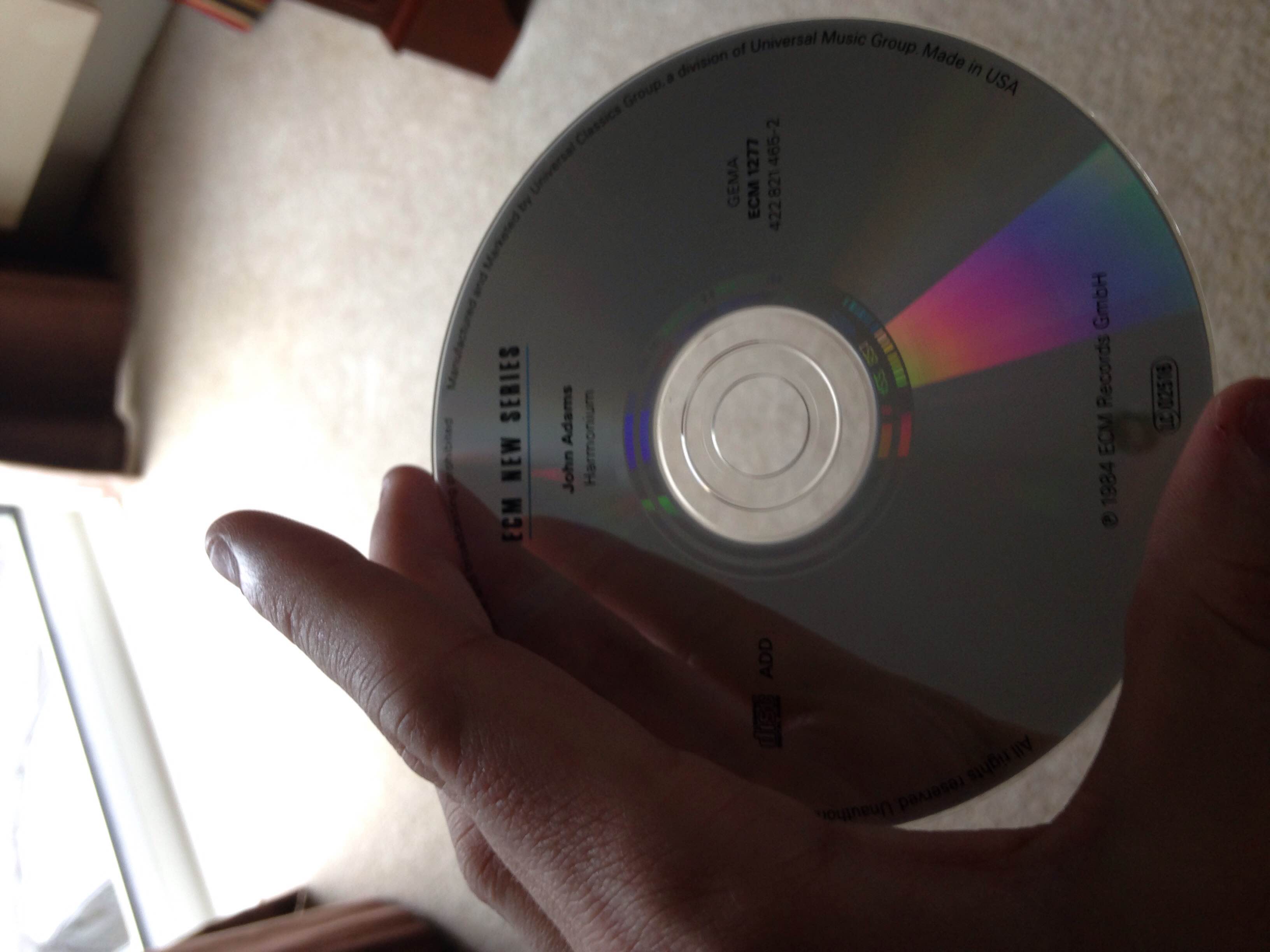 A CD being held up to the camera